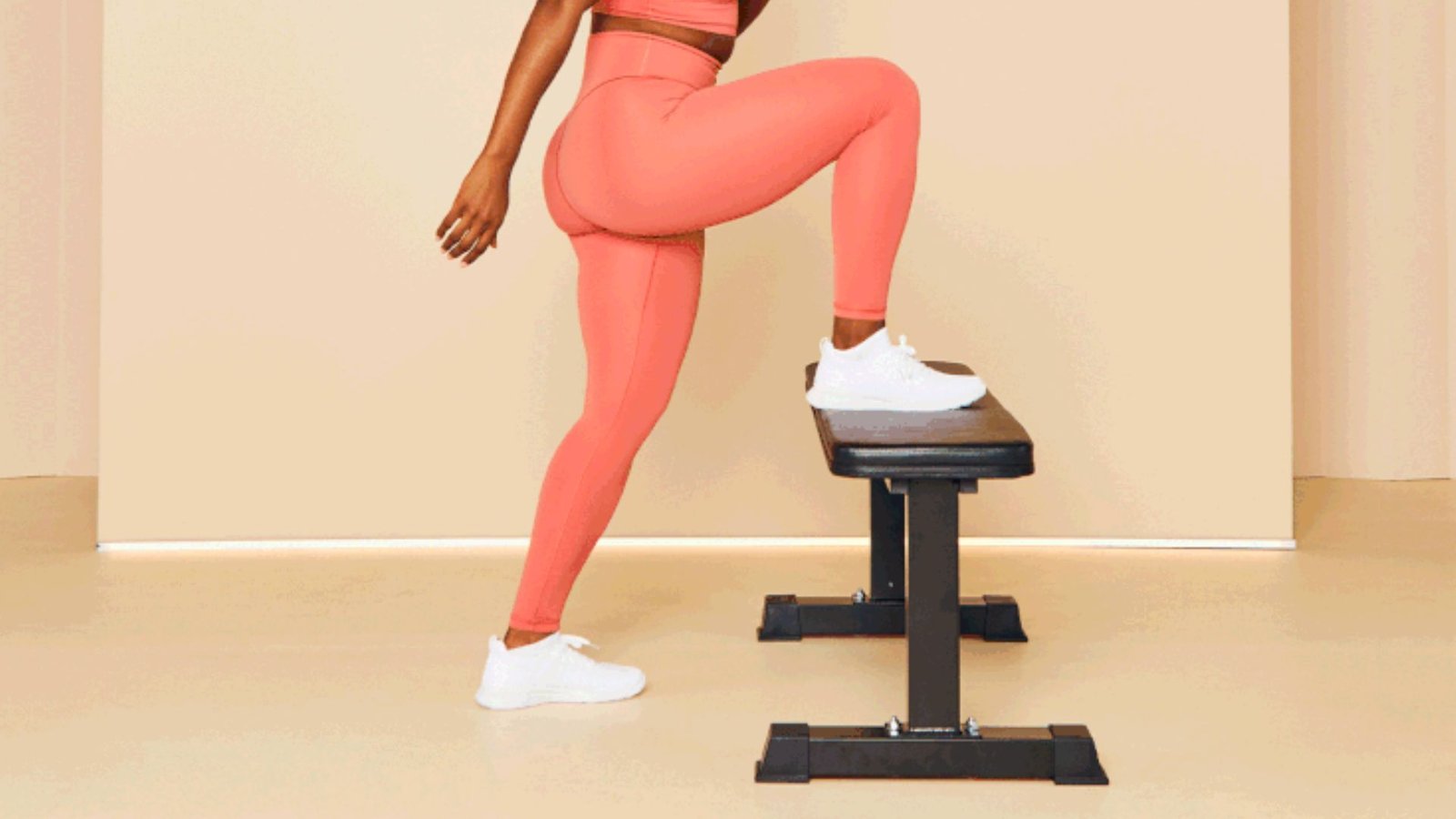 woman stepping onto a workout box with knee drive to improve leg strength and stability.