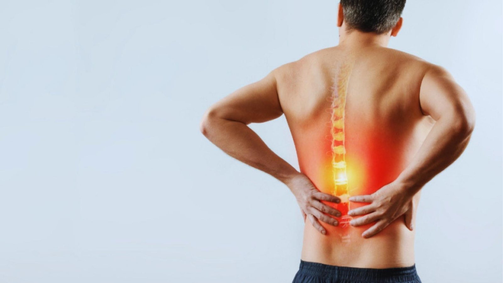 Man with lower back pain holding spine showing highlighted lumbar injury from squats.