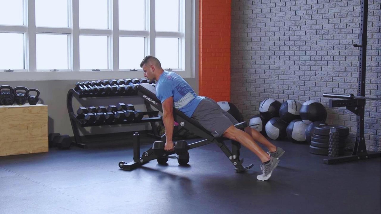 Man doing chest supported incline bench dumbbell row on Rogue bench, better back gains form.