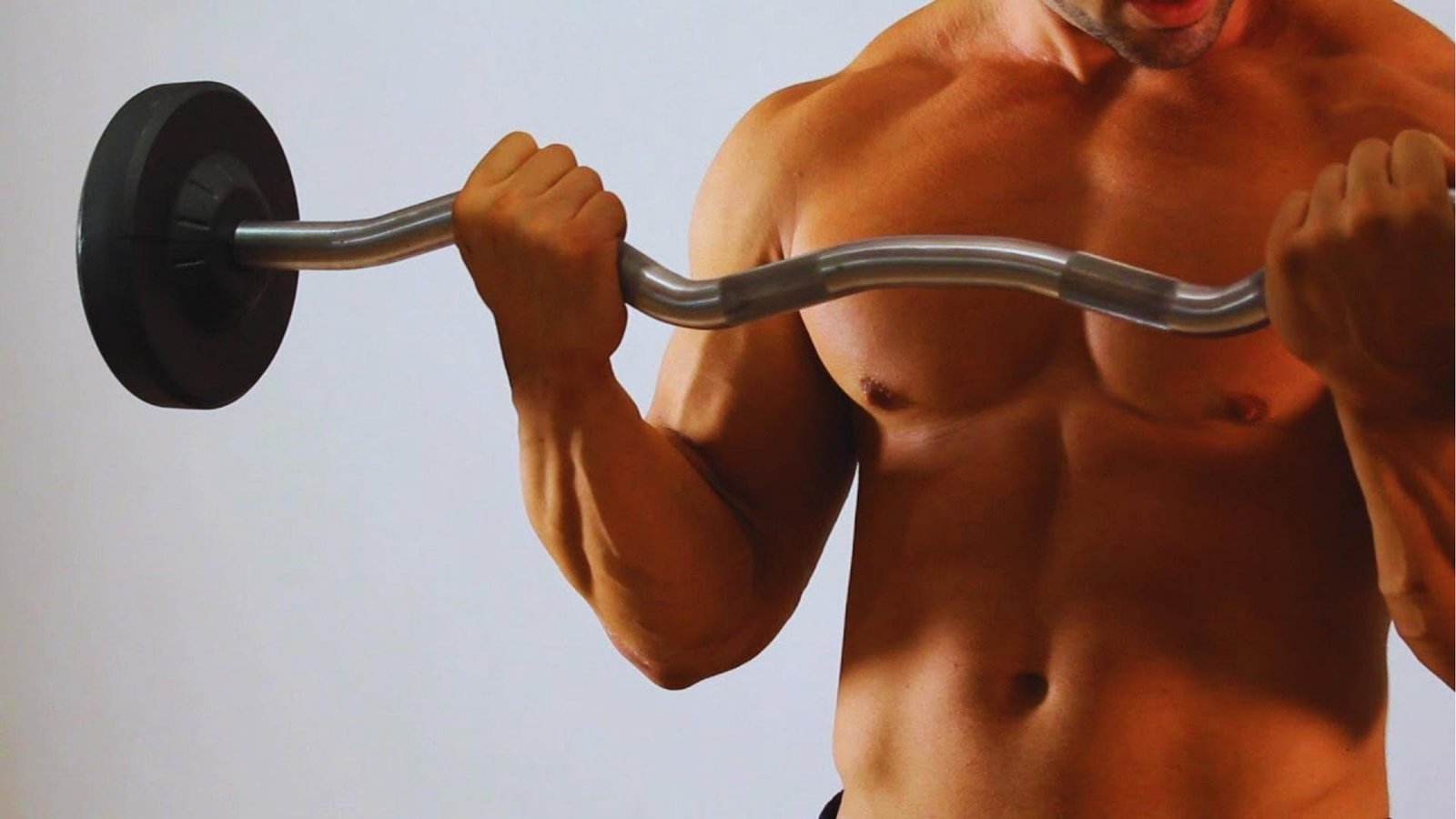 Man doing barbell bicep curls with EZ curl bar close up, arm muscle building exercise.