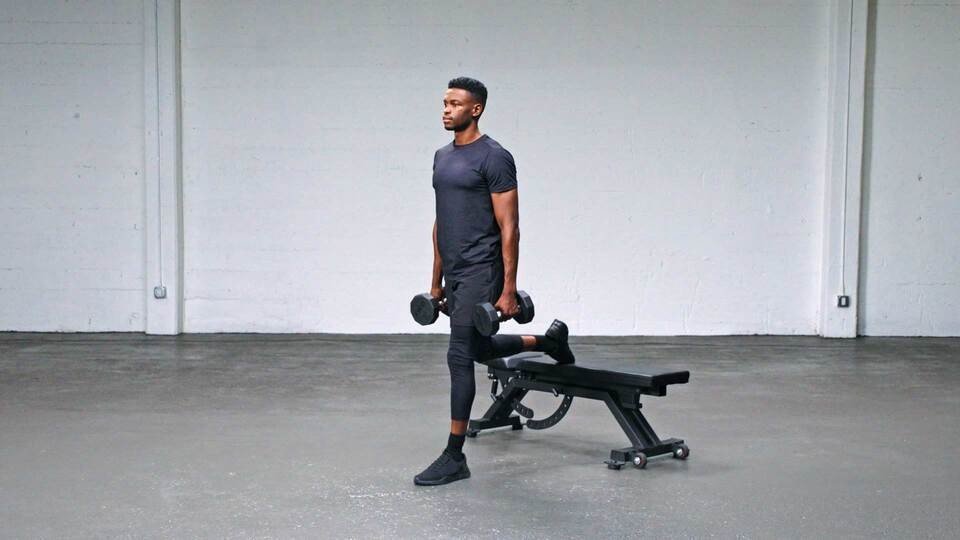 Man performing a Bulgarian split squat with dumbbells.