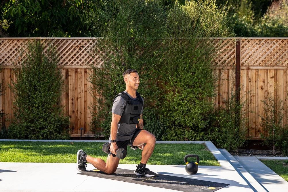 Person performing dumbbell quad exercises for muscle growth