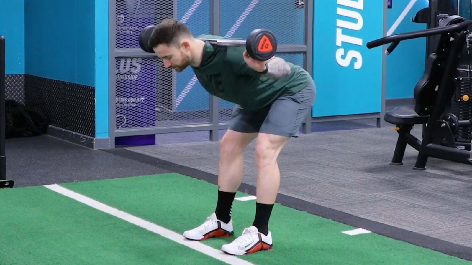 man performing a barbell good morning exercise with proper form.