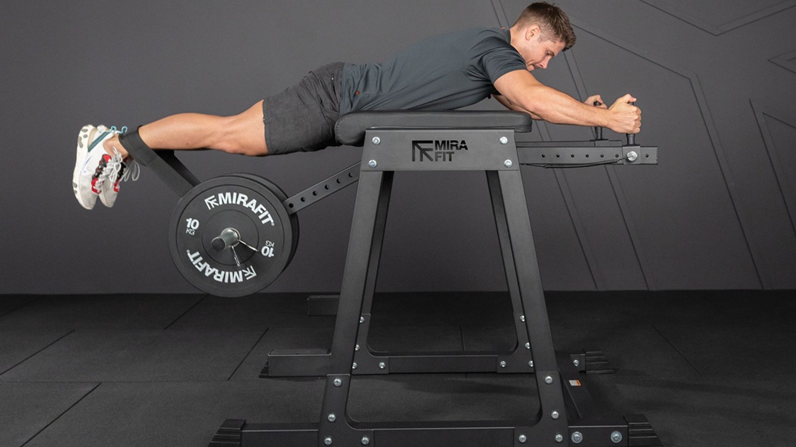 man performing a reverse hyperextension on a gym machine.