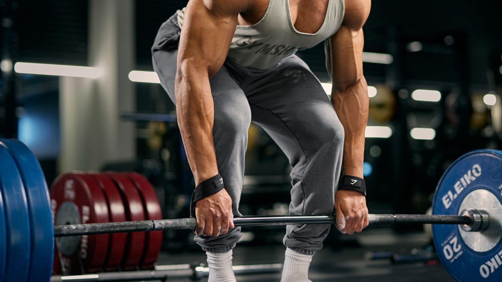 man performing a sumo deadlift with proper wide stance and form.