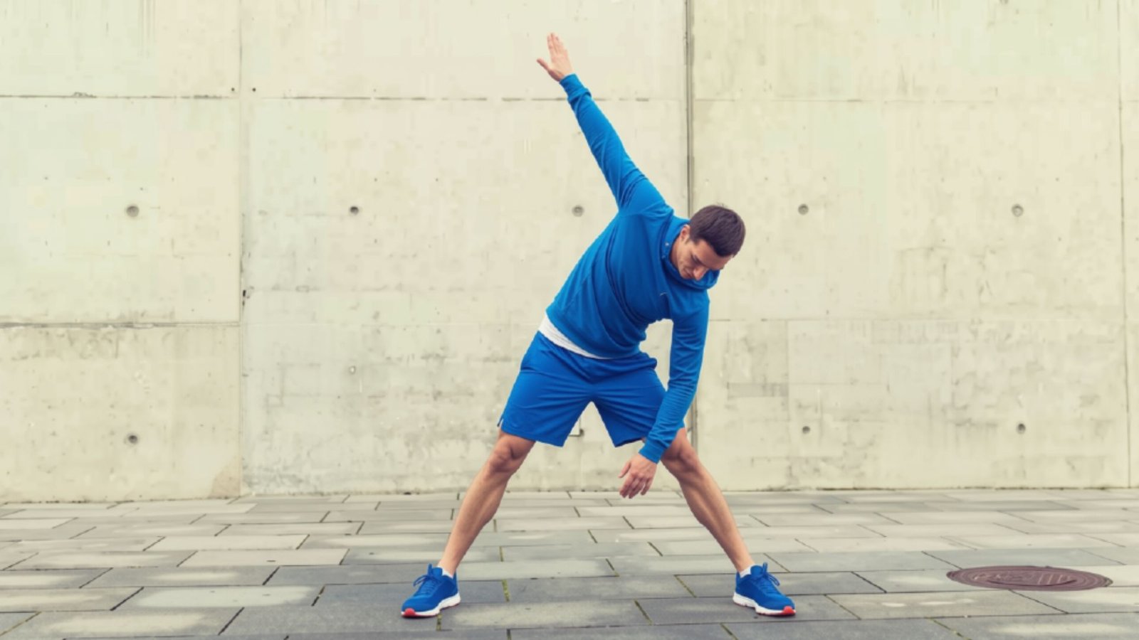 Fitness trainer demonstrating a horizontal pulling movement using a resistance band to strengthen the upper back.
